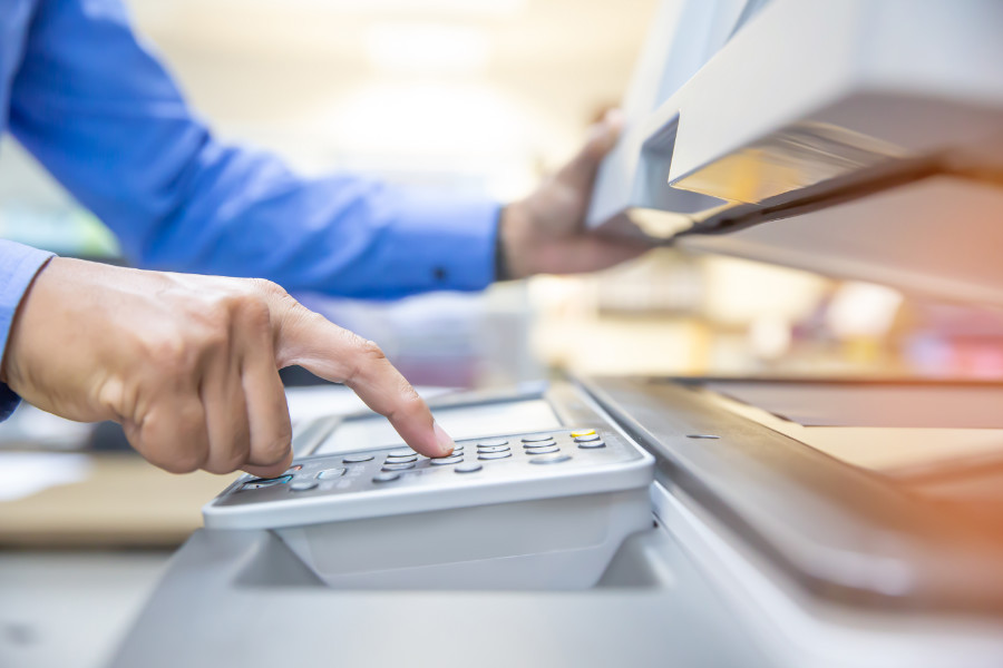 Businessmen are using photocopiers, scanning documents papers in